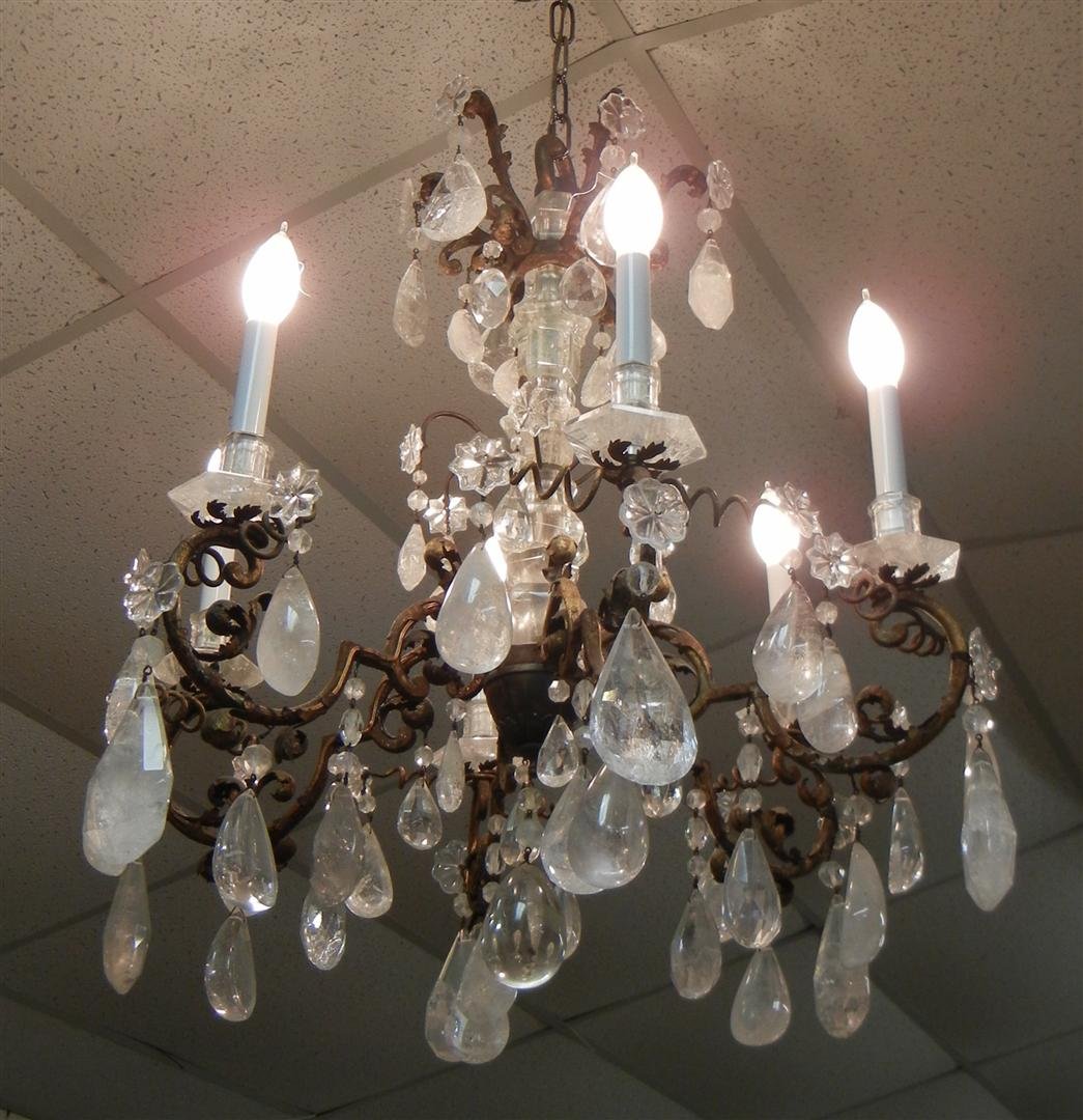 Louis XVI Rock Crystal Six Branch Chandelier: 19th century Louis XVI rock crystal, two-tier chandelier, each with six branches, dore' bronze arms laden with large rock crystal drops and carved rosettes with bobeches. The center post is covered wi