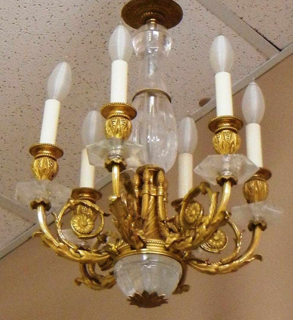 Dore' Bronze & Rock Crystal Chandelier: 20th century dore bronze chandelier with rock crystals. Chandelier has a six light rock crystal center post with attached bobeches and lower cap, curve branches with acanthus leaf. Chandelier measures
