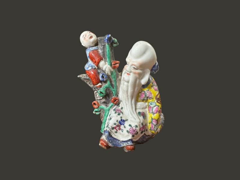 Small Chinese porcelain figure of Buddha and baby: A Small Chinese porcelain figure of Buddha and baby measuring 5 1/2" x 6" in.