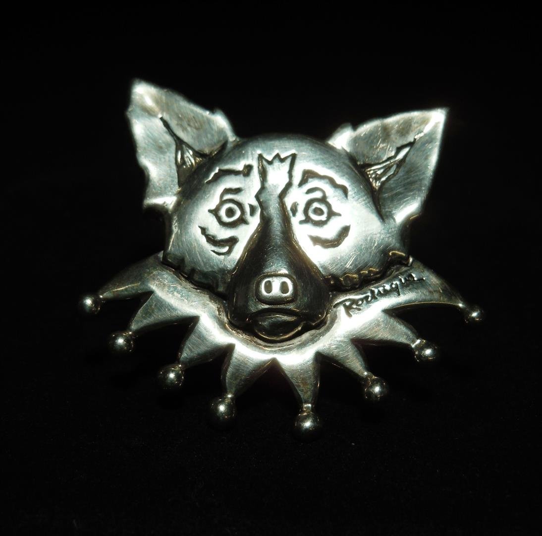 George Rodrigue, "Blue Dog" Sterling Brooch: A sterling brooch by Cajun artist George Rodrigue of his famous "Blue Dog." The pin is marked "Rodrigue" in multiple places and is also marked "sterling" (see photos).