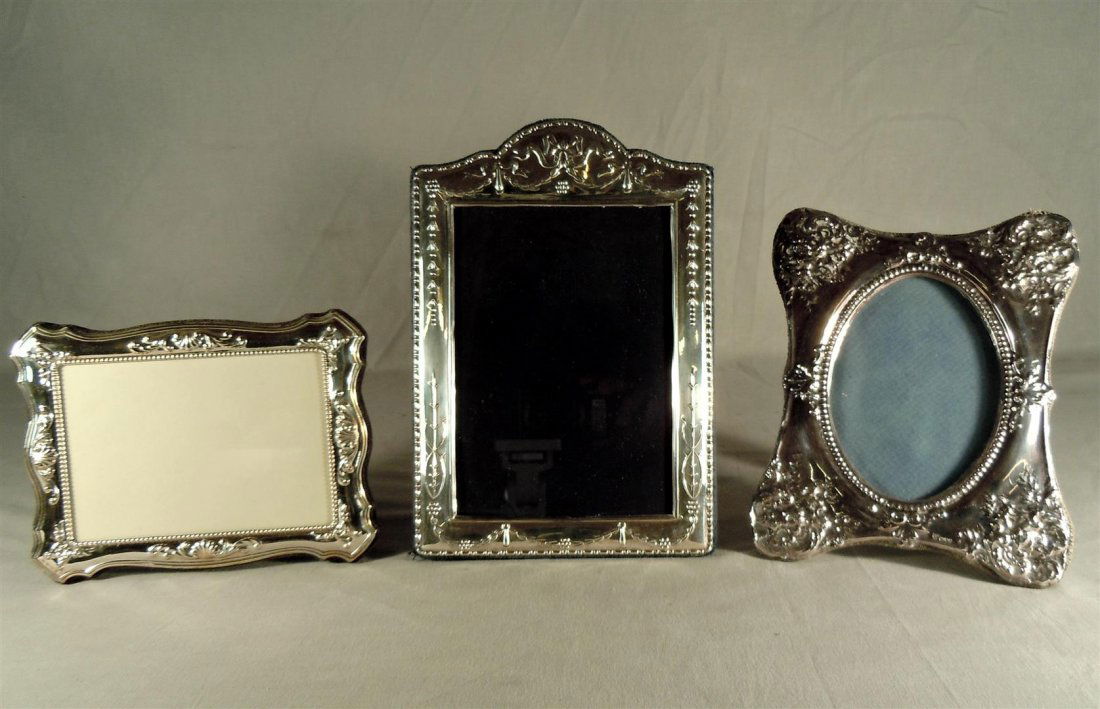 Three Sterling Silver Picture Frames: Three sterling silver picture frames (measurements from left to right in photo). First frame measures 5 1/2" x 7 1/4." Second frame measures 4 1/2" x 6 1/2." Third frame measures 8" x 6 1/2." Maker's