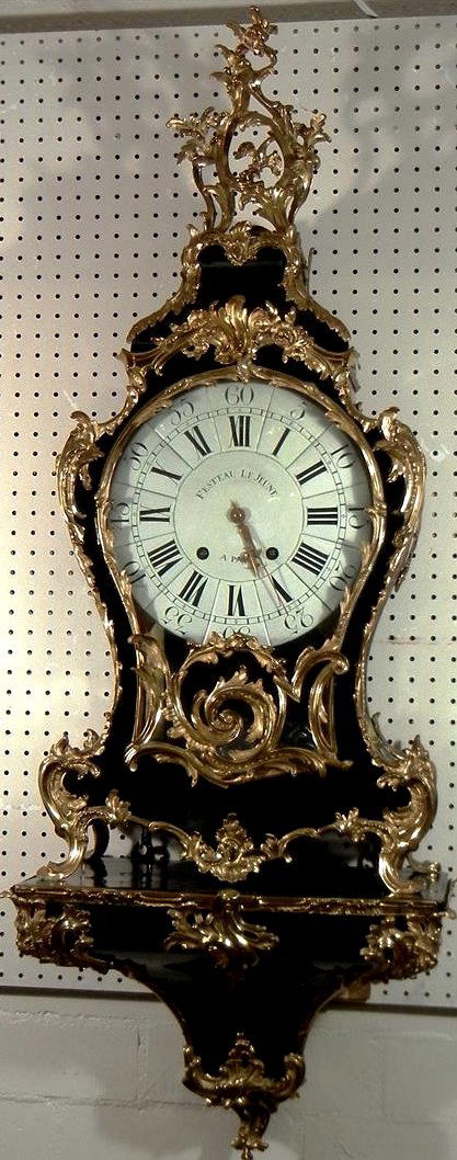 Louis XV Ebony Striking Bracket Clock: Louis XV ebony striking bracket clock with bracket, circa 1750. Clock reads, "Festeau Le Jeune A. Paris." Cartouche shaped case, mounted with scrolled ormolu with eagle in pierced pendant, white ename