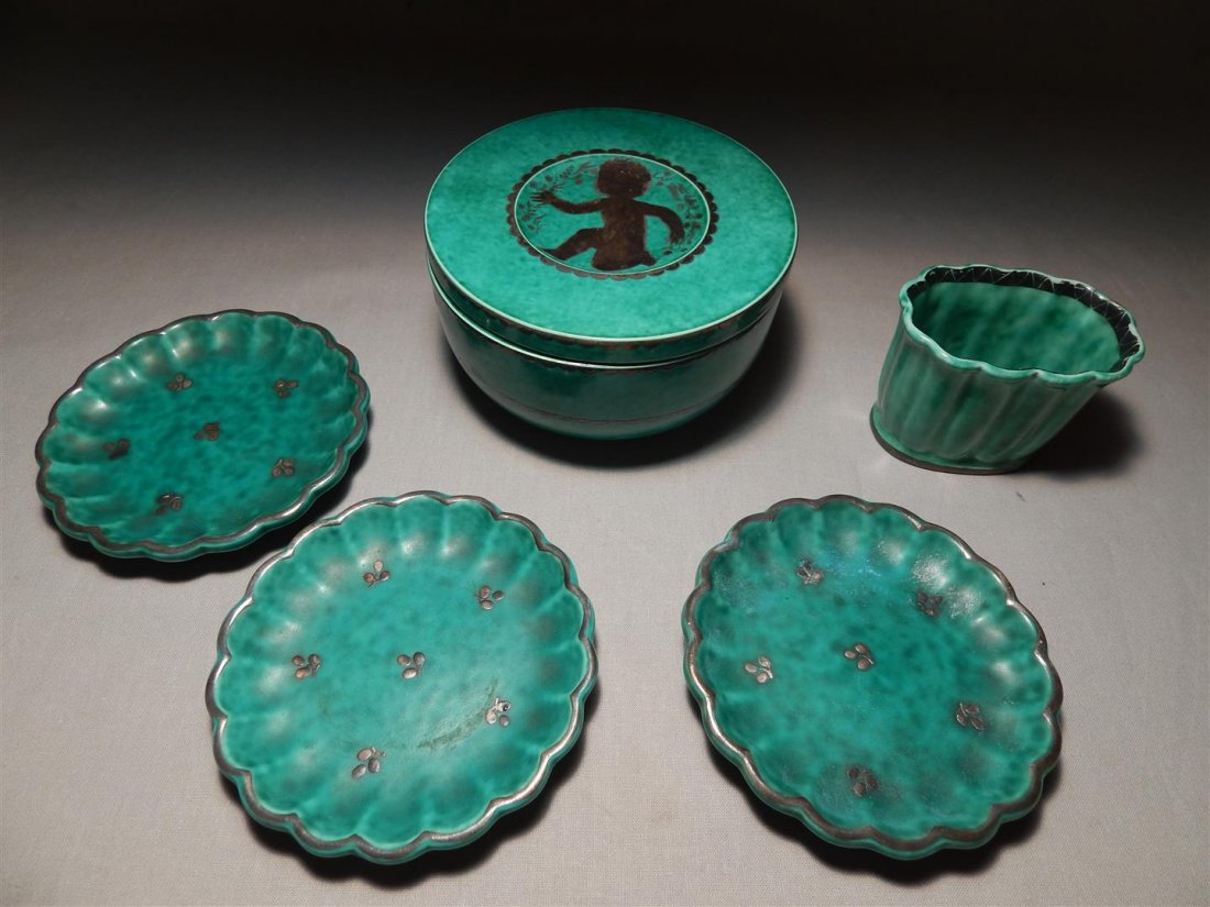 Gustavberg Argenta Swedish Pottery (5 pieces): Decorated green Gustavberg Argenta Swedish pottery consisting of: a toothpick holder (measuring 2 1/2" x 3," and three saucers (measuring 4" in diameter) and lidded box with cherub (2 3/4" x 4 3/4.").
