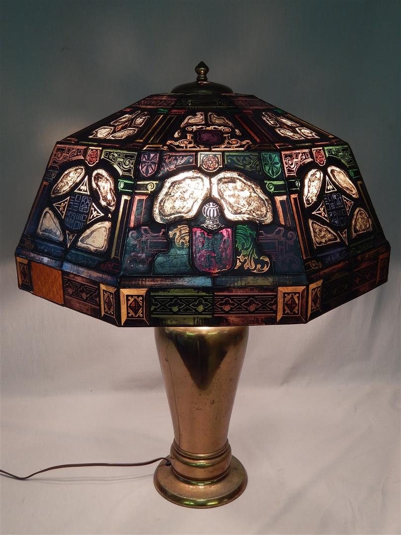 Stained Glass and Painted Lamp: A stained glass and painted lamp shade with solid bronze base. Two of the tiny panels along the bottom rim have been replaced with gold glass. See image 8. The lamp measures 29" x 23."