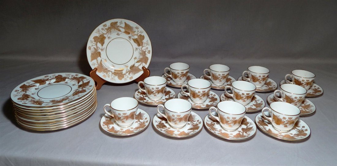 24 Pieces Wedgwood China Plates, Gilt Vine Leaf: 24 pieces of Wedgwood China plates in the gilt vine leaf pattern consisting of: 12 cups and saucers and 12 plates (measuring 8" in diameter). All pieces are marked (see photo).