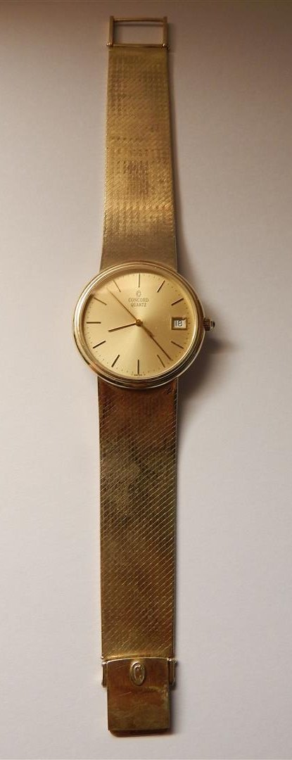 Gents 14k Gold Concord Watch: A gents 14k Concord gold watch weighing 46.90 gross dwt.