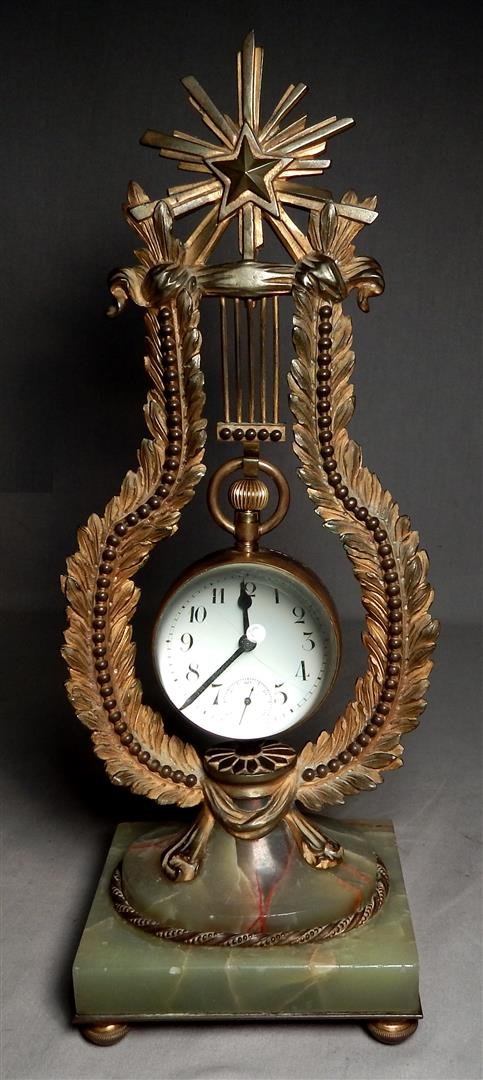 Crystal Ball Clock in Ornate Gilt Bronze and Onyx Stand: A crystal ball clock. Ball clock measures 3 1/2" x 2 1/2", stand measures 13 1/2" x 5".