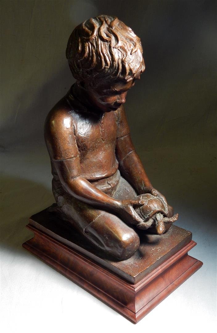 Bronze Sculpture of Boy Holding Turtle by Charles: A bronze sculpture by American artist Charles Cropper Parks (1922 - 2012) depicting a boy holding a turtle. Signed parks and marked '70. Measures 11 1/2" x 4 3/4" x 8".