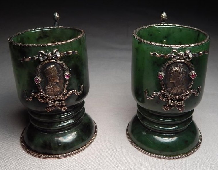 Pair of Faberge Jade Sterling Miniature Cups with Ruby: A pair of Faberge jade and sterling miniature cups with ruby embellishments. Measures 2 1/2" x 1 1/2".