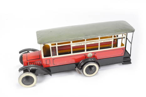 Burnett Limited Lands End Tin Bus, Wells. BL 12121: Highly unusual bus by Burnett Ltd. London, England circa 1925. Known as the Land's End bus. Delicate and detailed lattice work on tin. Windup works along with adjustable front wheels. Housing present