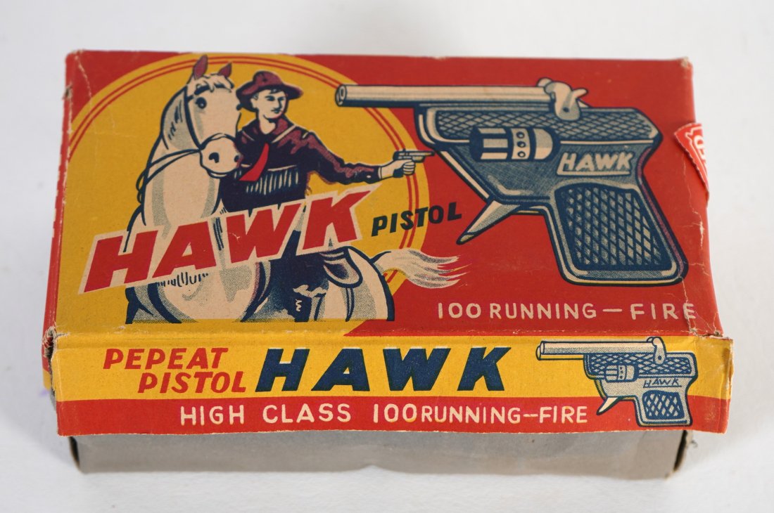 Japan 12 Hawk Pistol Cap Guns in Store Display Box: Old store stock. Box has original 12 cap guns all in great condition. Cap guns measure 3" long