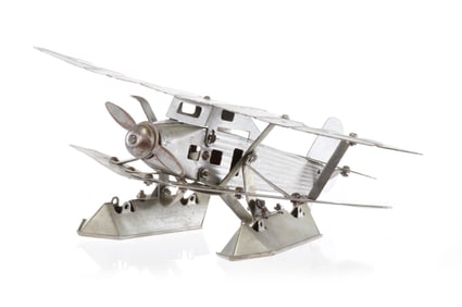 Silver Steel Biplane Toy Found in South America