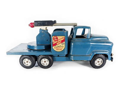 1960's Pressed Steel Buddy L Anti-Aircraft Unit Truck: This pressed steel toy has rubs and scratches in the paint. It has plastic tires. The bumper, headlights, and GMC emblem are intact. The decals are intact with slight wear. The searchlight and trailer