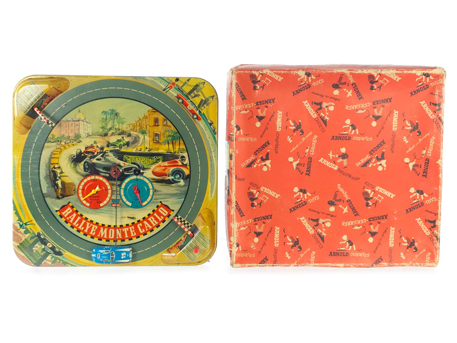 1940s Arnold #420 Windup Rallye Monte Carlo Boxed: 1940's Arnold #420 Rallye Monte Carlo tin windup racetrack toy with the original box and key. This interactive tin toy features a sleek racing car that speeds around the track, stopping at each rally