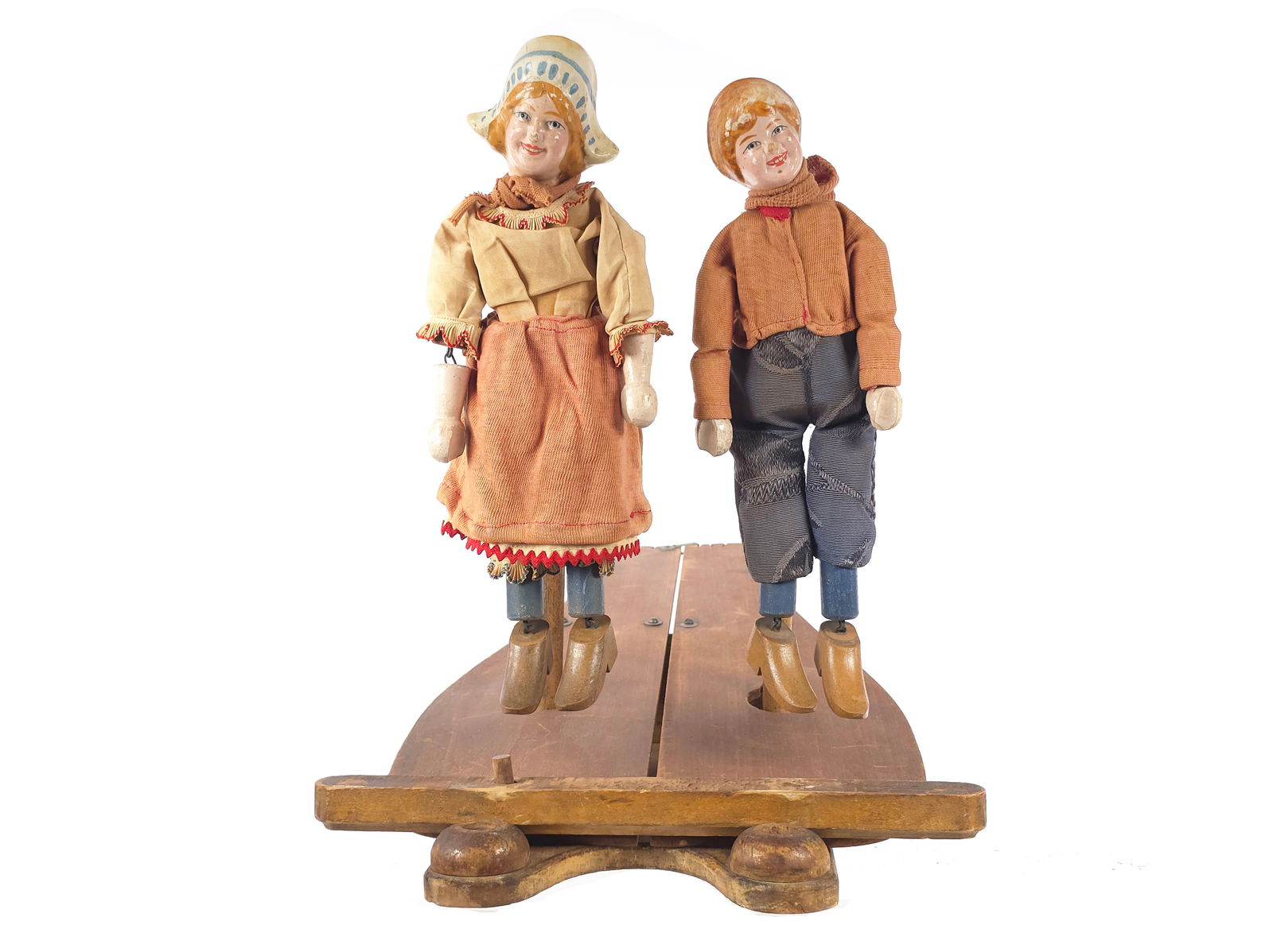 Schoenhut Jolly Jiggers Dutch Children Dancing Dolls: A wonderful early wooden toy, circa 1903, the Schoenhut Dancing Dutch Boy and Girl Jolly Jiggers dolls dance and frolic while tapping out a jig. The position of the dancers can be changed to a center