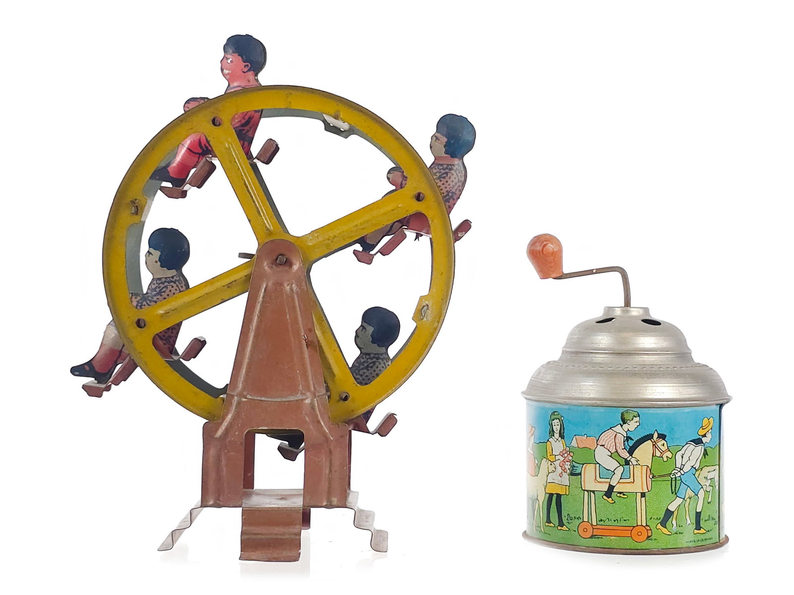 (2) Fun Toys: German Noise Maker & Tin Litho Ferris Wheel: A pairing of two fun toys including a vintage tinplate crank music box manufactured in Germany during the early 20th century. Made of tin with a wooden hand-crank lever for winding, it features lithog