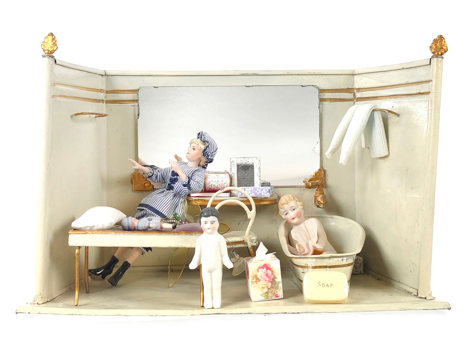 French Miniature Dollhouse Bathroom w/Dolls & Accessories: This vintage French miniature dollhouse bathroom scene features a delicate painted metal room set from the early 20th century with a hinged compartment in the back designed to be filled with water