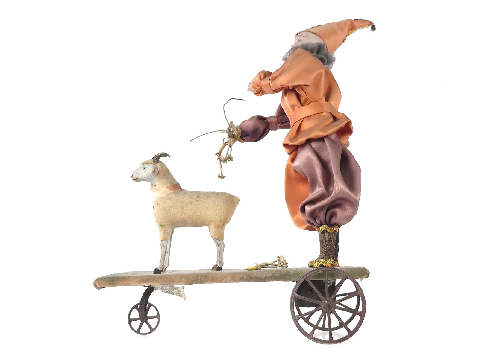E. Heubach German Clown with Sheep on Windup Platform: Antique Ernst Heubach German bisque clown in a satin clown’s outfit with fuzzy goat on a windup platform. We were unable to test the windup mechanism due to not having a long enough key. The back of