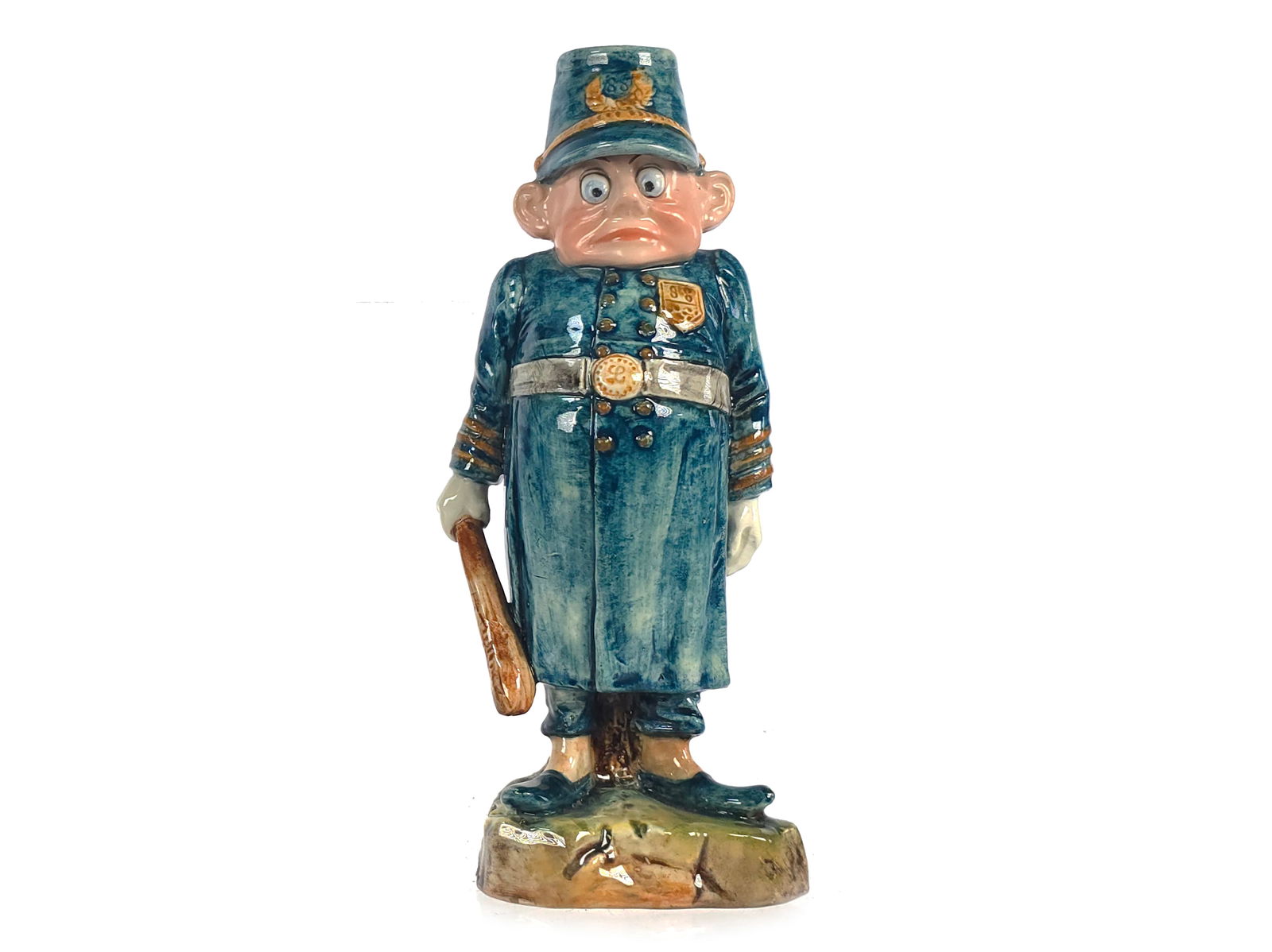Majolica Palmer Cox Brownie Policeman Candlestick: This antique Majolica pottery Palmer Cox "Brownie" Policeman character figurine candlestick holder features a stump-like base and depicts the Policeman from the Palmer Cox Brownie stories. The piece