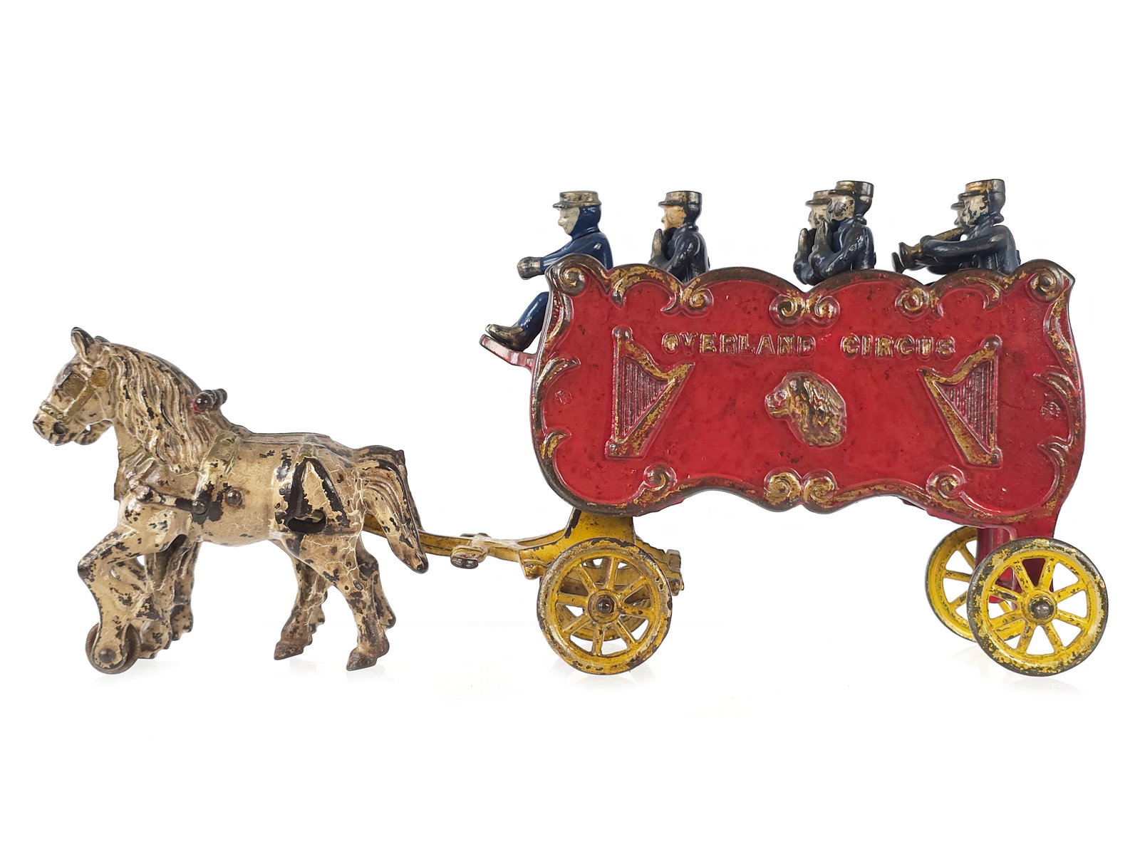 Kenton Overland Horse-Drawn Band Wagon Cast Iron: Cast iron band wagon in original paint. A well-loved toy with one of the fourteen players missing. This is a prewar variation measuring approximately 14" L x 7" H.