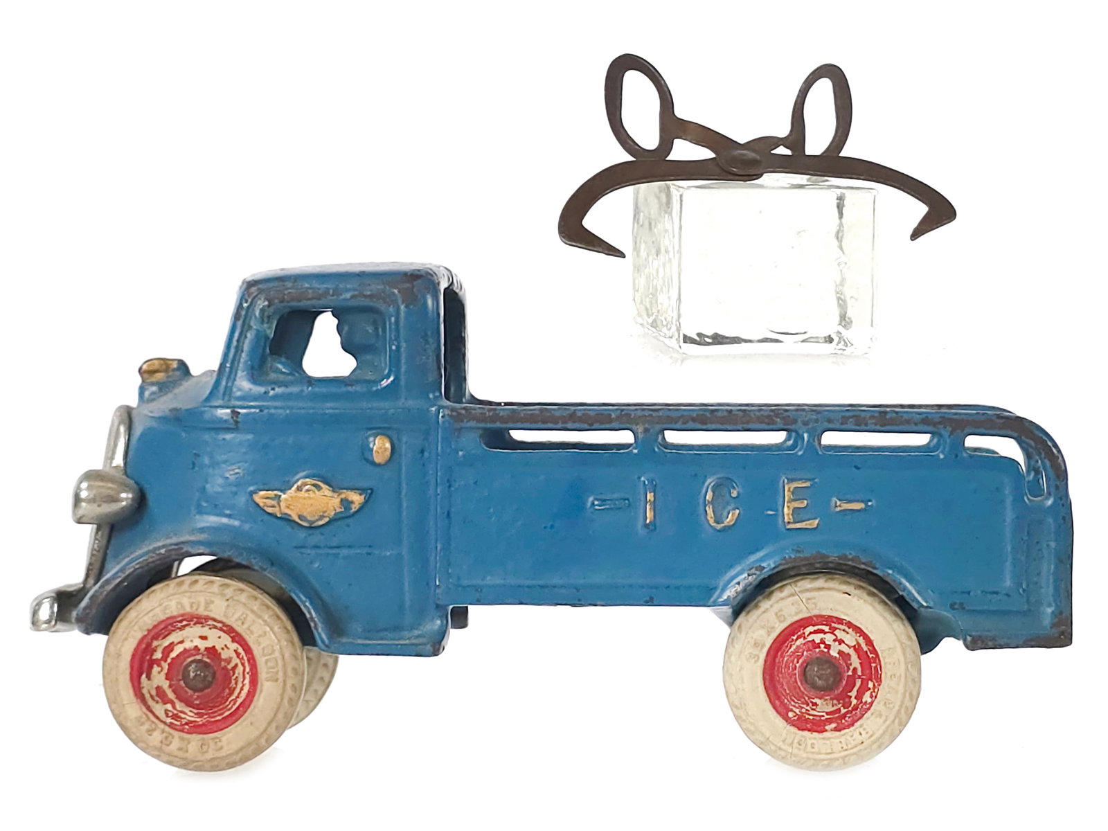 Blue Cab Over Arcade Ice Truck Cast Iron: Blue Arcade ice truck with cab-over design. The toy features a 1930s nickel-plated grille, original paint with gold highlights, and tires that appear original with proper red insets. Ice tongs and ice