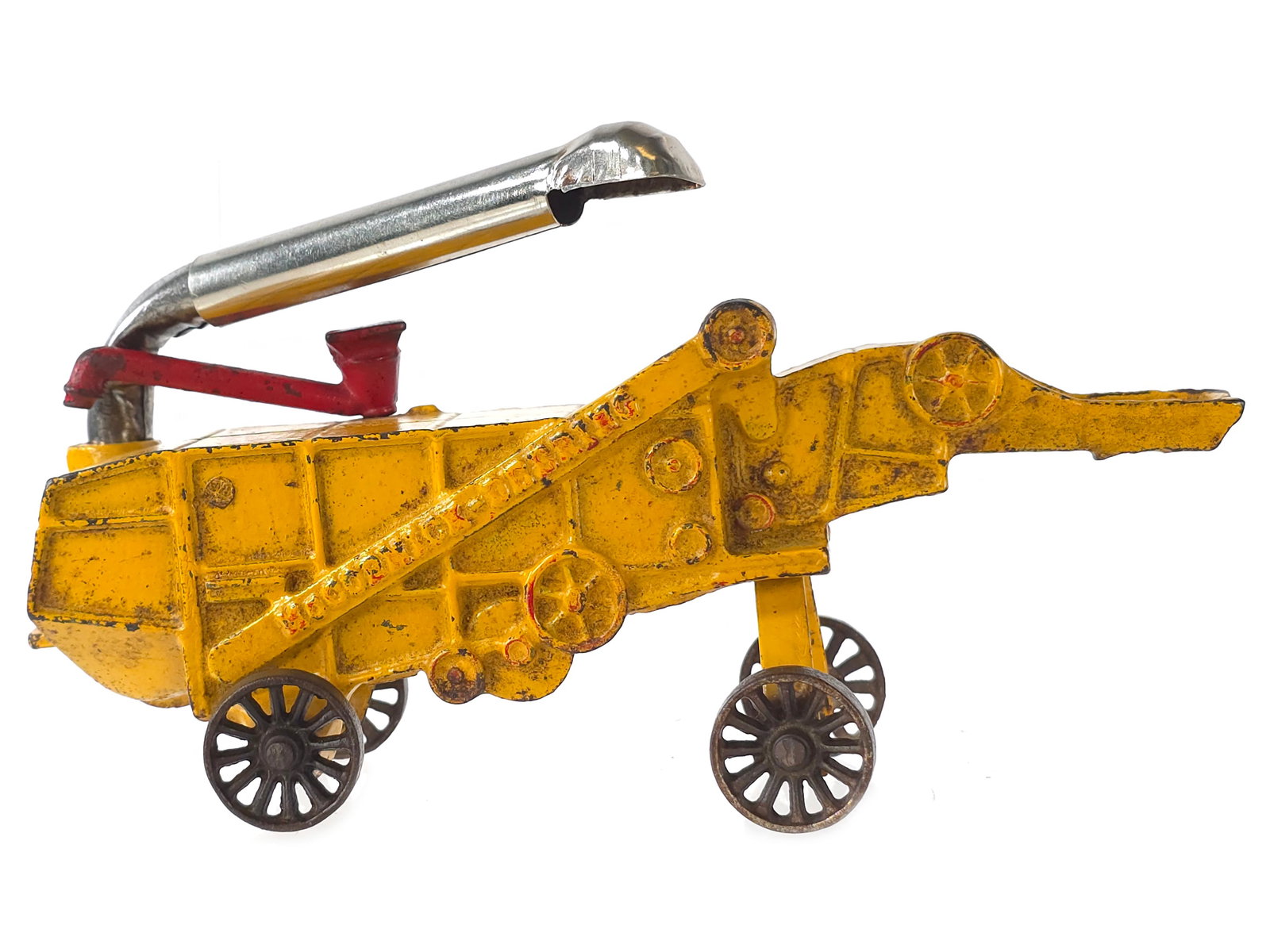 Yellow Arcade Toys Thresher Cast Iron with Sticker: Big-scale yellow Arcade Toys thresher. The toy retains nice original paint and a plated pipe and presents as a larger and impressive farm implement. It measures approximately 9" L.