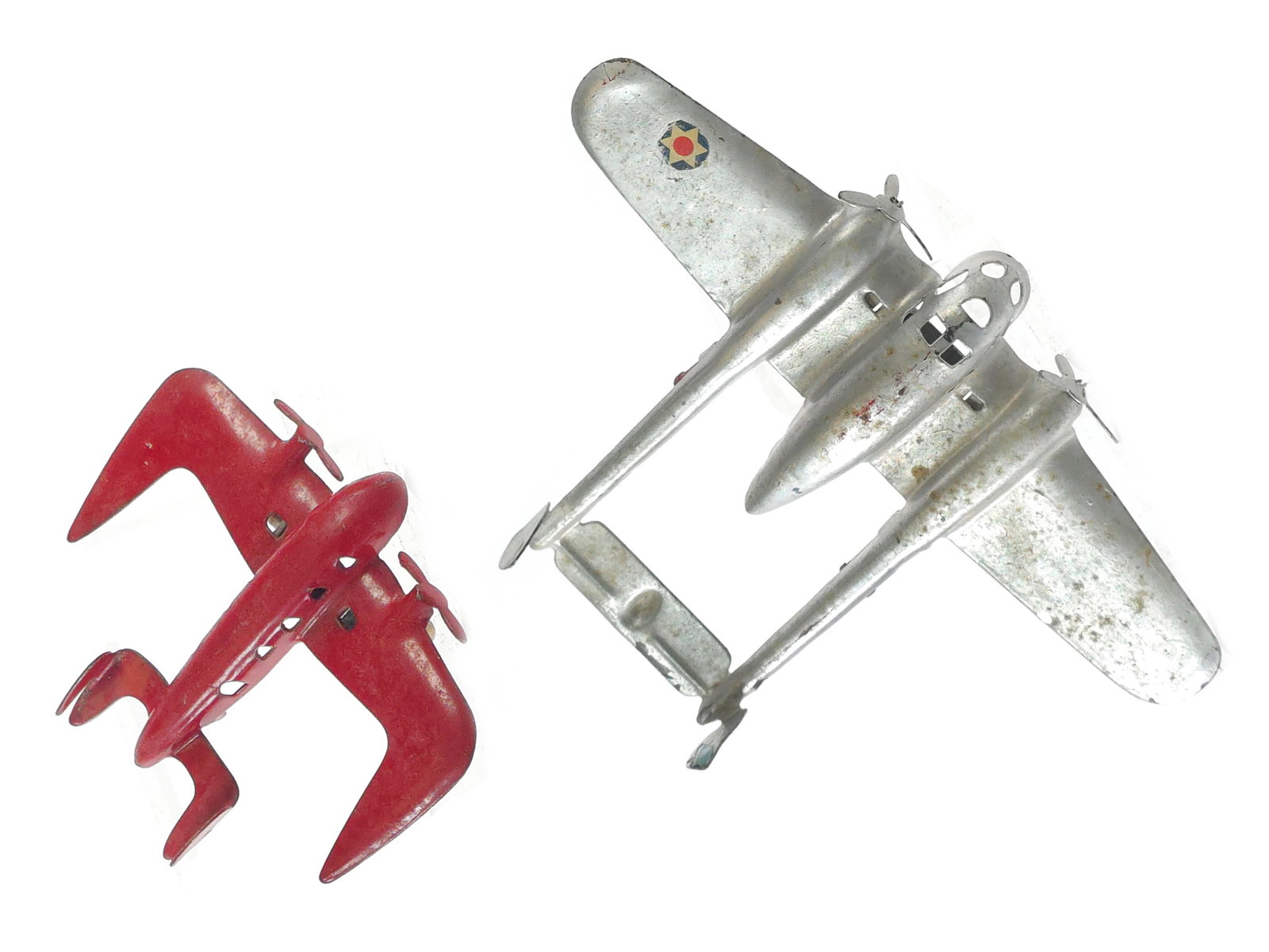 (2) Wyandotte Pressed Steel Space Age and Military Planes: Set of two pressed steel airplanes by Wyandotte. One example is a fanciful space-age twin-prop design, and the other is inspired by a twin-engine military aircraft. Both retain original paint and pres