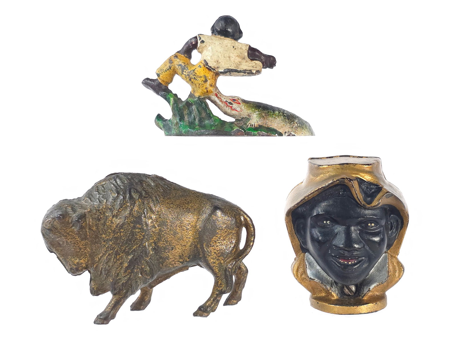 (3) A.C. Williams Buffalo & Two-Faced Banks & Bottle Opener: Two cast iron still banks and a cast iron bottle opener. Included is an A.C. Williams No. 7948 Buffalo Bank in plain gold, which measures approximately 3.2" H. Also included is an A.C. Williams Two-Fa