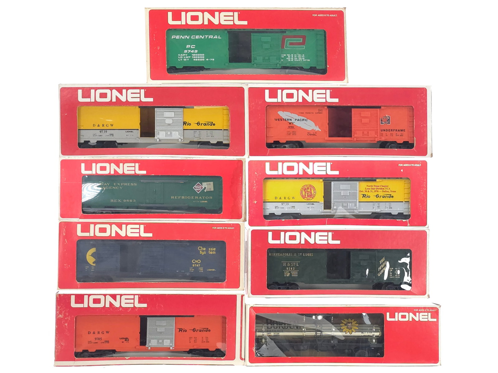 (9) Lionel Box Tank Car Lot Boxed: An assortment of nine Lionel box and tank cars including Penn Central No. 9749, Western Pacific No. 9723, Railway Express Agency No. 9863, Rio Grande Nos. 9739, Chessie Double Door No. 9747, Denver Ri