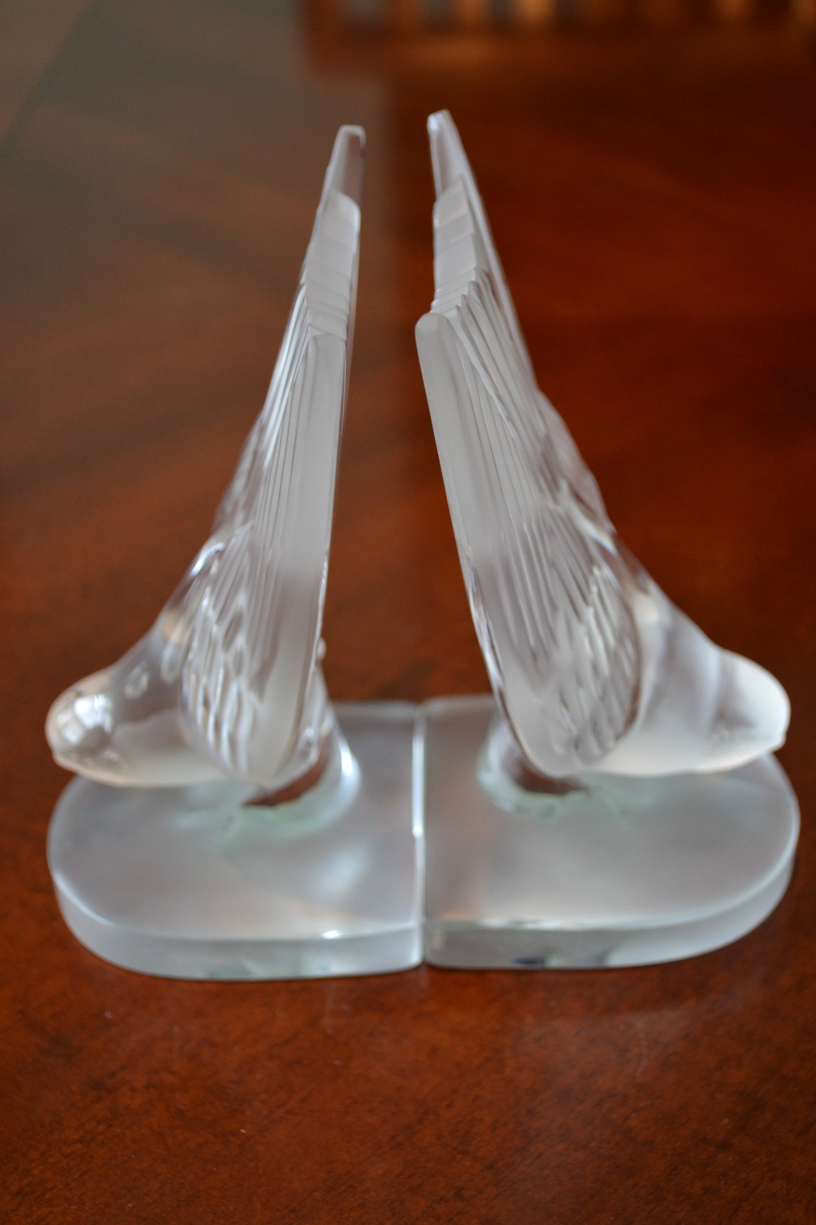Lalique Crystal Hirondelle Swallow Bird Book Ends: Lalique Crystal Vintage Hirondelle Swallow Book Ends (Pair) in the form of a swallow bird swooping with its tail raised on a rounded base. Lalique crystal defines elegance and affluence as a lifestyle