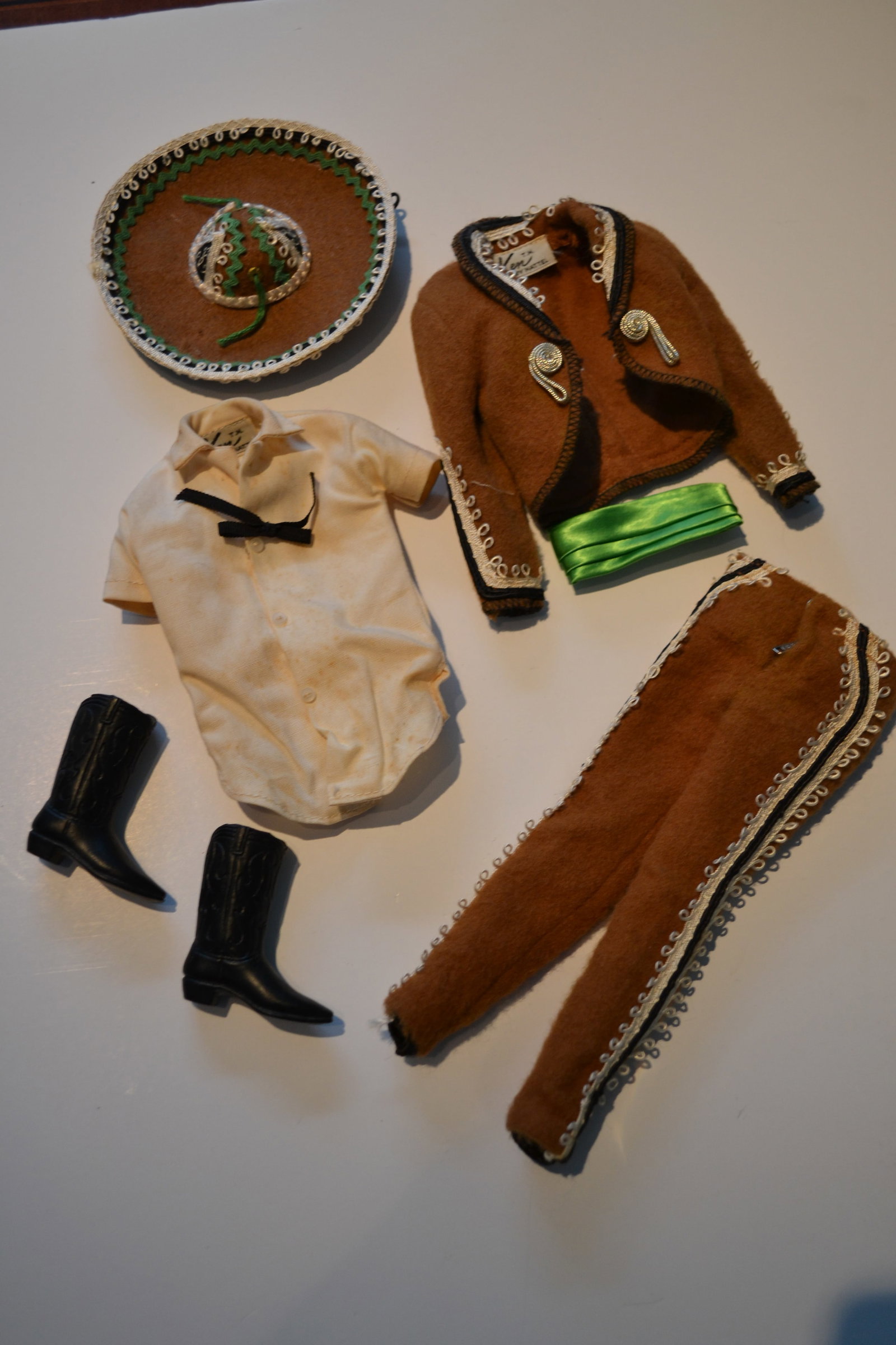 Mattel Ken in Mexico Outfit #0778 Travel Costume: Mattel Ken in Mexico Outfit #0778 Travel Costume Ken wears his costume to a fiesta! He's the dashing senor in his brown coat and trousers with black and white trim, green cummerbund, white shirt, blac