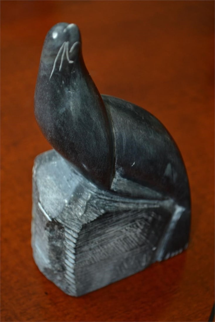 Inuit carved Seal on Rock by Eddie Omnik Signed: EDDIE OMNIK Sculpture - INUIT Soapstone Carving of a Seal on a rock one piece. Signed Eddie Omnik (1950-2009) was born in Point Hope, Alaska. He's a part of the long tradition of carving among Inuit P