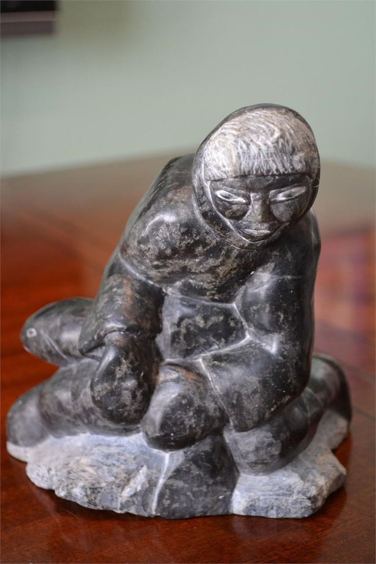 Inuit Sculpture Hunter with Fish Signed Numbered: Inuit Sculpture Hunter with Fish carved Soapstone. On the bottom it is numbered, dated c 81, and signed in syllabic possibly by Augia Pataja Numbered 5A-14370 In excellent condition. Measures 7 x 4 in