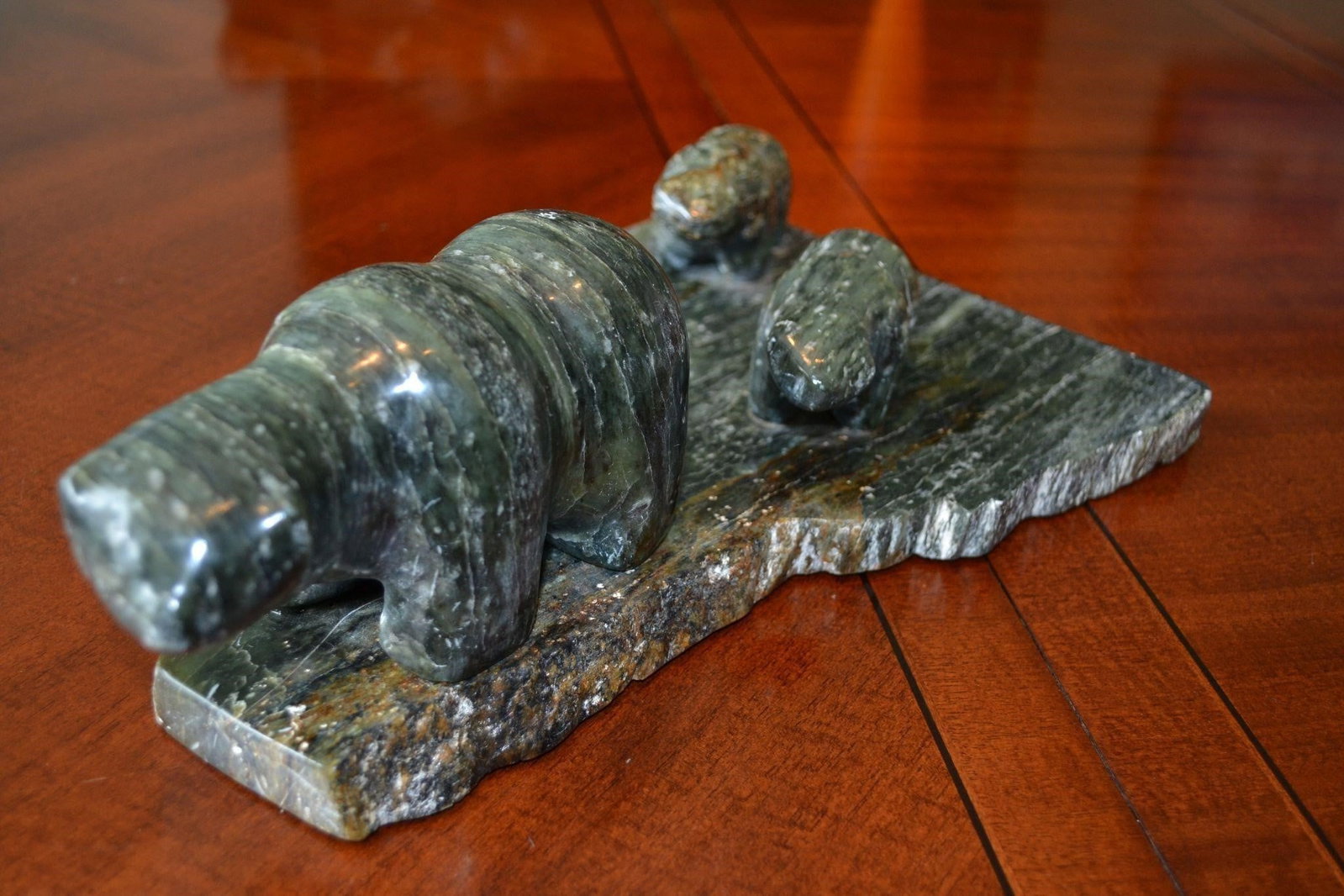 Polar Bear & Cubs Stone Sculpture by Doomwan: Polar Bear with Two Cubs Stone Sculpture by Doomwan. The animals are carved from the same stone as its base. Could be a rare find. Measures: 8.25 x 12.75 x 4 in Height Weight 9 lbs.