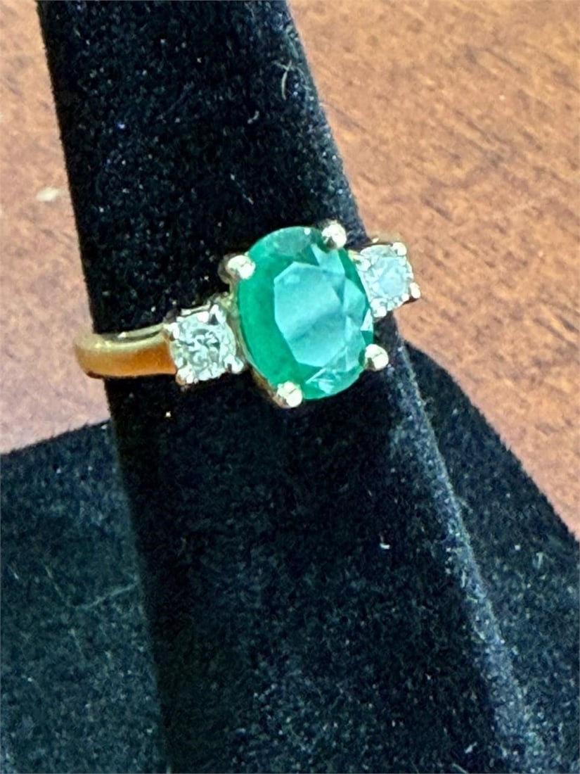 Emerald and Diamond Ring 14 KT: Emerald and Diamond Ring 14 KTVintage three-stone ring featuring a central oval-cut emerald flanked by two accent diamonds in a 14k gold setting2.67 gram Total Weight