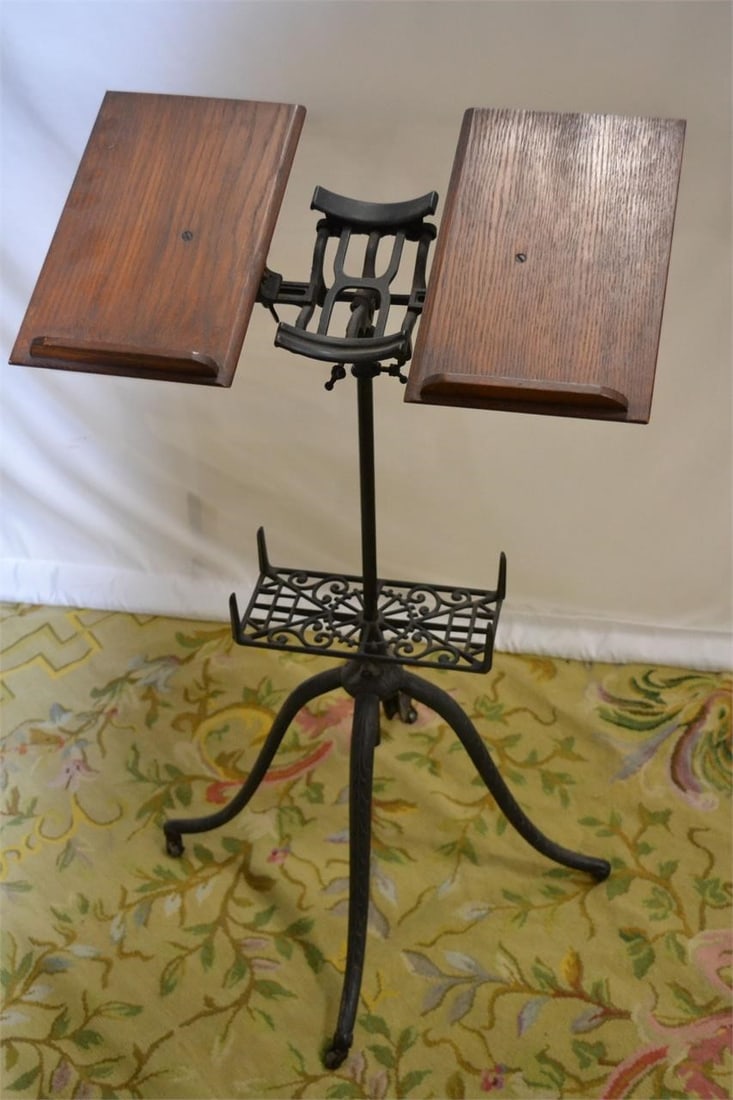 1800s VICTORIAN BOOK STAND RETICULATED: 1800s VICTORIAN BOOK STAND RETICULATED IRON FOUR LEGS ON CASTORS Measures 22.25"W x 38"H