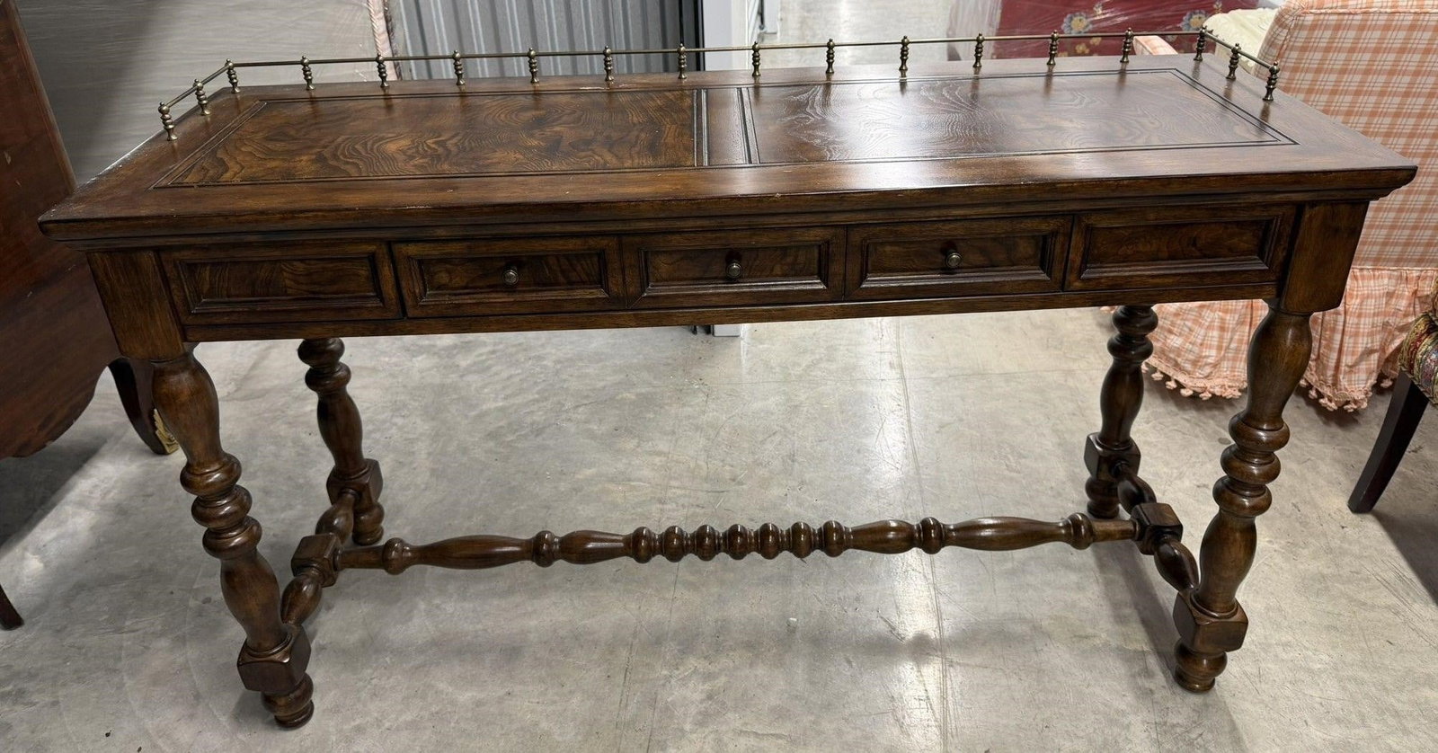 Console or Writing Desk Barley Twist: Antique English or Spanish style console table featuring classic bobbin-turned or barley twist legs or spinet writing desk featuring a brass gallery railing. Wood appears to be WalnutMeasurements 54"W