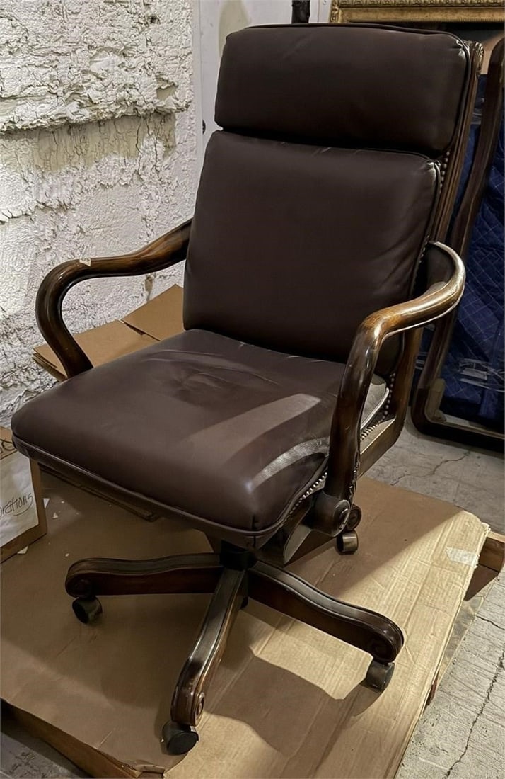LEATHER EXECUTIVE SWIVEL TILT ARMCHAIR: Executive leather office chair characterized by its distinctive gooseneck (or shepherd's crook) wooden arms and a high, upholstered backMeasurements 43" H