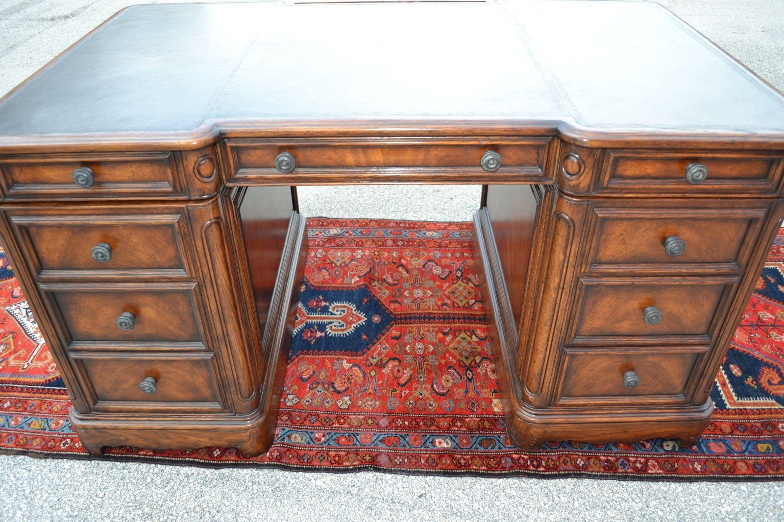 THEODORE ALEXANDER PARTNERS OAK DESK LEATHER TOP: THEODORE ALEXANDER PARTNERS OAK DESK WITH BLACK LEATHER TOP Features 5 Drawers and one door, Opposite side finished with faux openings. Sides are panel finished. Desk Measures 56"L x 34"D x 30"H in ex