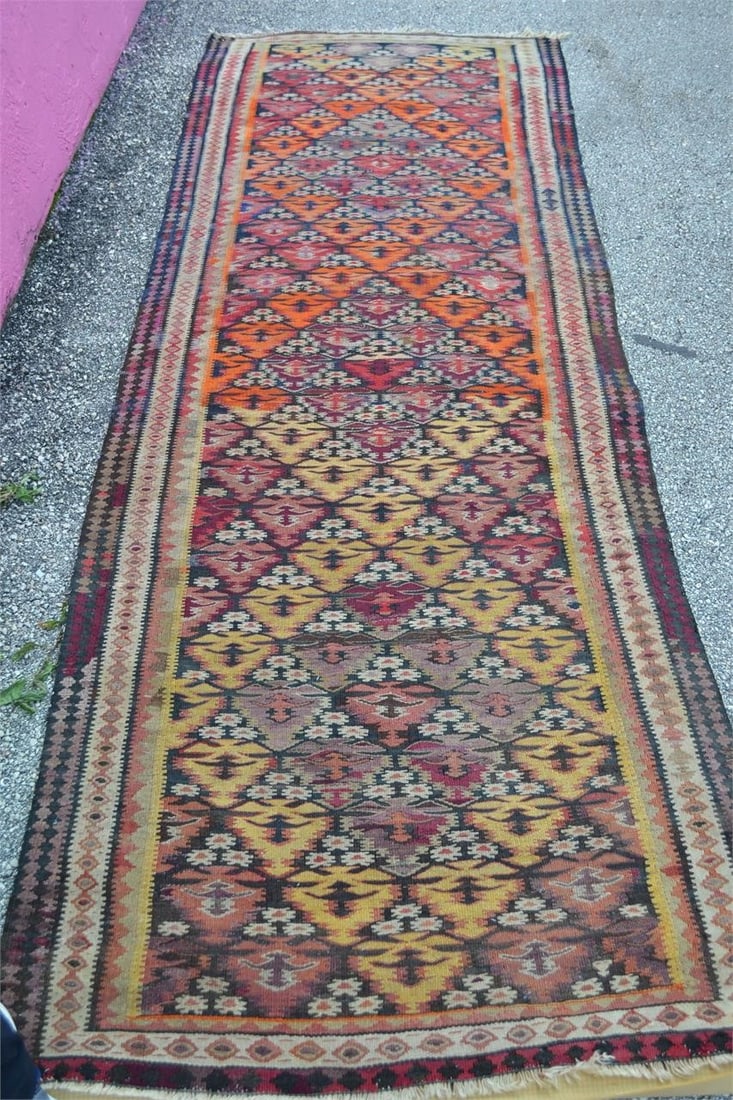KILIM SHAHSEVAN TRIBAL RUNNER HANDKNOTTED WOOL RUG: KILIM SHAHSEVAN TRIBAL RUNNER HAND KNOTTED WOOL AREA CARPET Colors of Red, Orange, Yellow, Gold, Cream and Burgundy. Has fringe on both ends. Measures 3'4" x 9'4" Good Condition