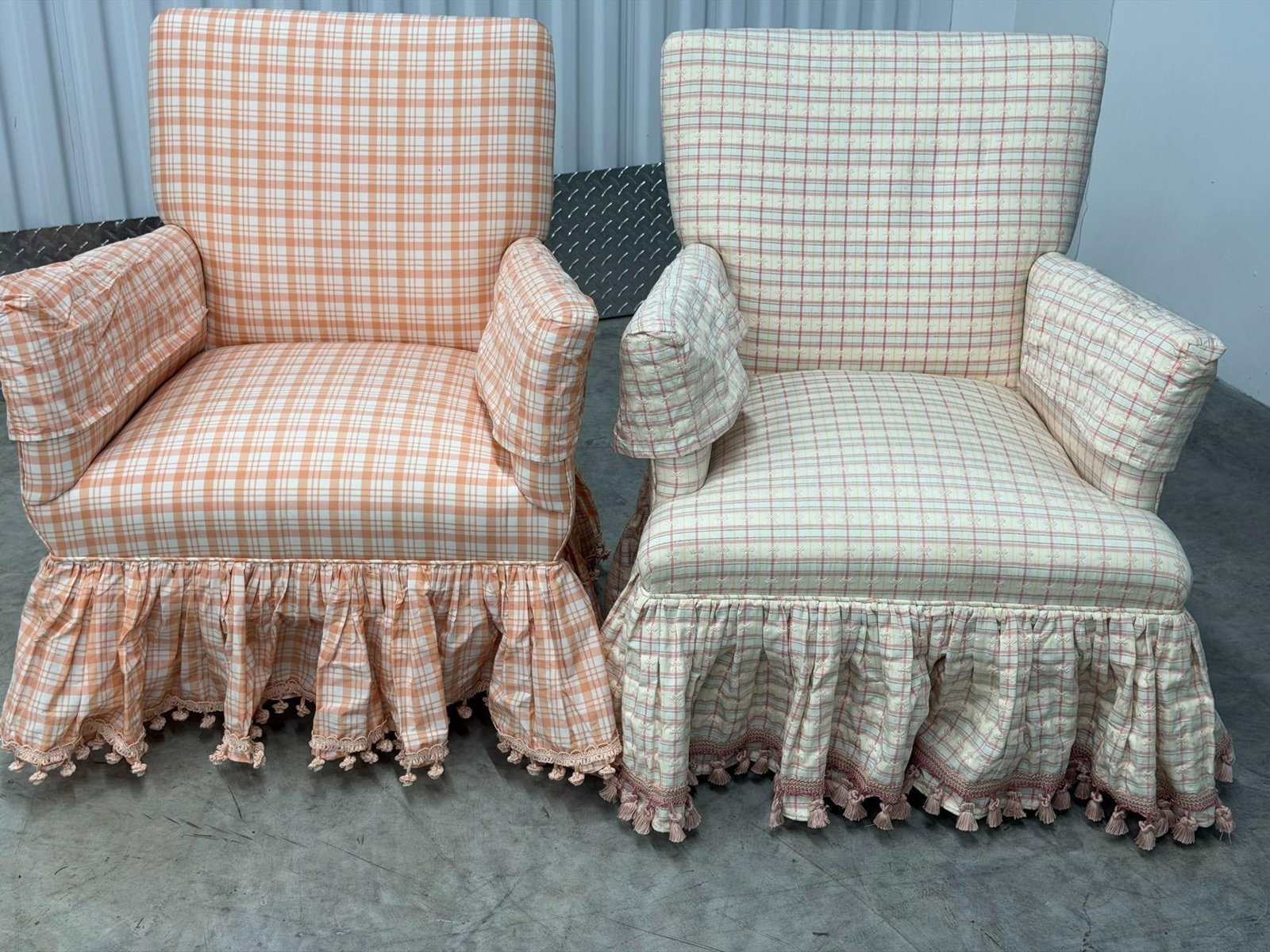 Pair Provincial-style Upholstered Armchairs: Pair Provincial-style Upholstered Armchairs with plaid fabric and a pleated skirt with tassels. Condition is very GoodMeasurements 23 1/2"W x 27"D x 31"H