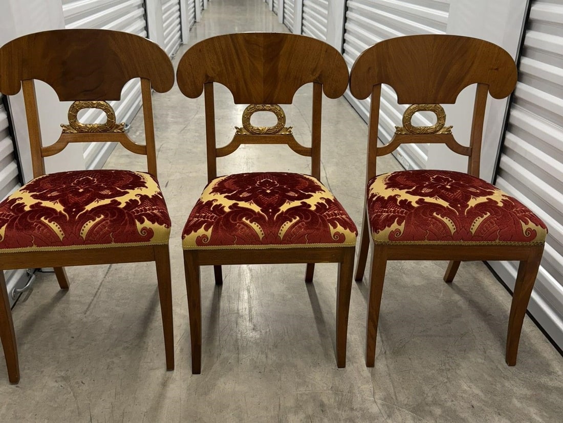 Set of 4 Biedermeier-style Side Chairs: Set of 4 Biedermeier-style Neo Classical side chair, characterized by its "Napoleon Hat" crest rail, wood veneer, with gilded decorative elements like wreaths. Beautiful Red and Gold Upholstered Seats