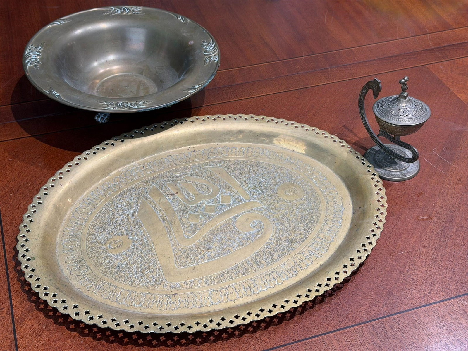 Vintage Middle Eastern Metalware Miscellaneous: Vintage Middle Eastern Metalware Lot of 4(1) Oval Brass Tray hand-engraved Arabic calligraphy and arabesque patterns, often associated with Islamic art from Syria or Persia. (1) Brass Footed Bowl (1) 