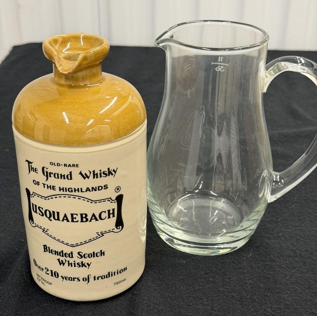 Vintage Lot of 2 Pitcher and Whisky Jug: Vintage Princess House Heritage Hand Blown Crystal Etched Floral Pitcher paired with a bottle of Usquaebach Old Rare Blended Scotch Whisky Ceramic Jug Both Measure 8"H