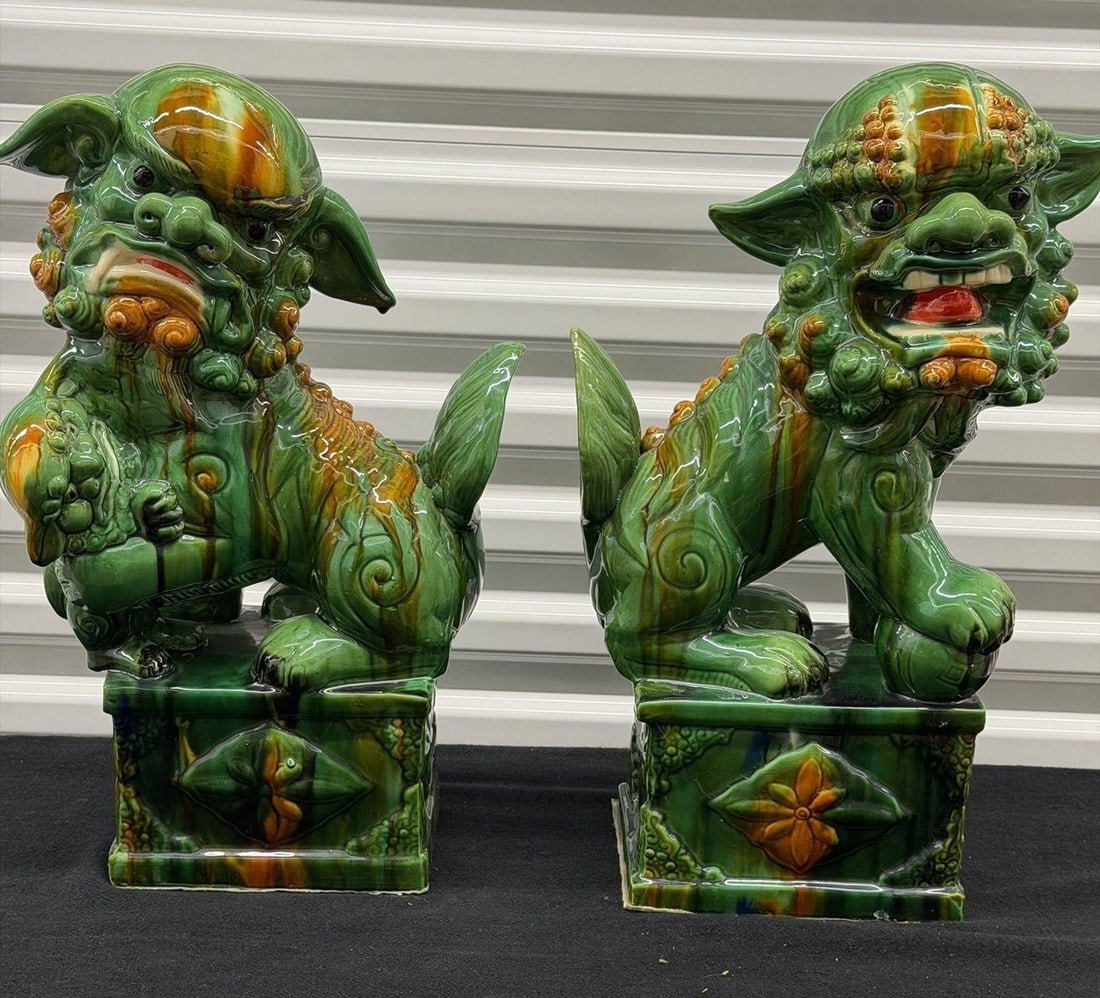 Vintage Pair Chinese Ceramic Foo Dog 21" Height: Pair of vintage mid-20th-century Chinese ceramic Foo Dog guardian statues, also known as Fu Lions or Shi. The statues feature a vibrant green and orange-yellow "sancai" style glaze with intricate trad