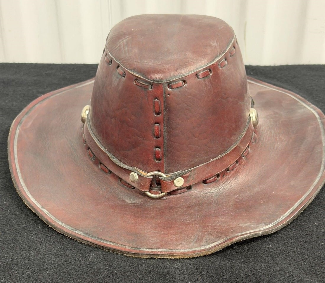 Brown Leather Cowboy Hat: Brown leather cowboy hat similar to western or outback style hats featuring decorative stitching and silver-toned hardwareSize 11