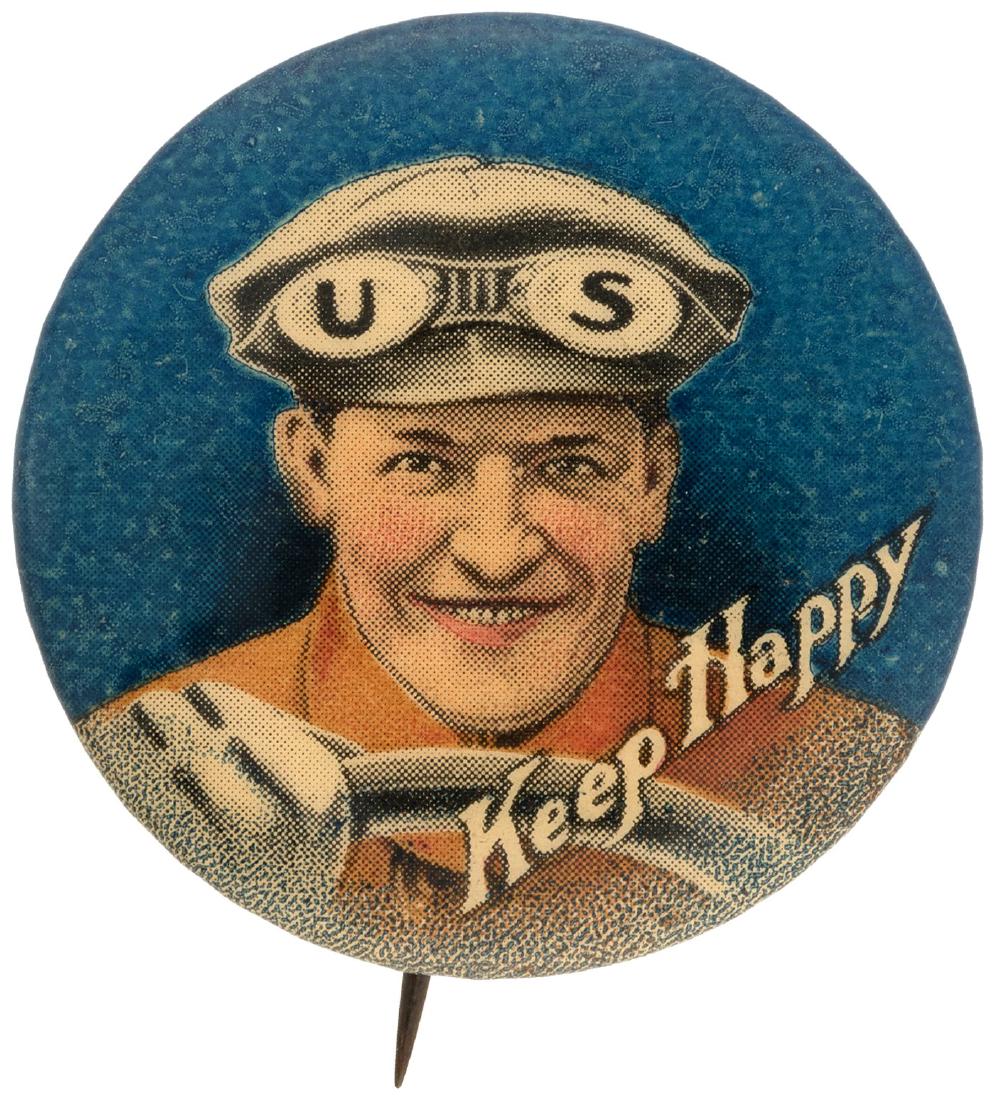 GRAPHIC AUTO DRIVER WITH GOGGLES PROMOTING U.S. RUBBER : 1.25" with W&H paper used only 1900-1912. Terrific color depiction of driver with one gloved hand on the steering wheel and the initials of the product on the lenses of the goggles positioned across t