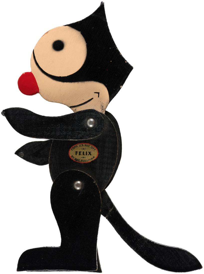 "FELIX" THE CAT STANDING/MOVABLE WOODEN FIGURE.: 6-7/8" tall jigsawed and painted thin wood. Decal on one side reads "Corp. U.S. Pat. Off - Felix - By Pat Sullivan." Nearly 100% remains. 1920s. Facial features on both sides. Shoulders and hips hinge