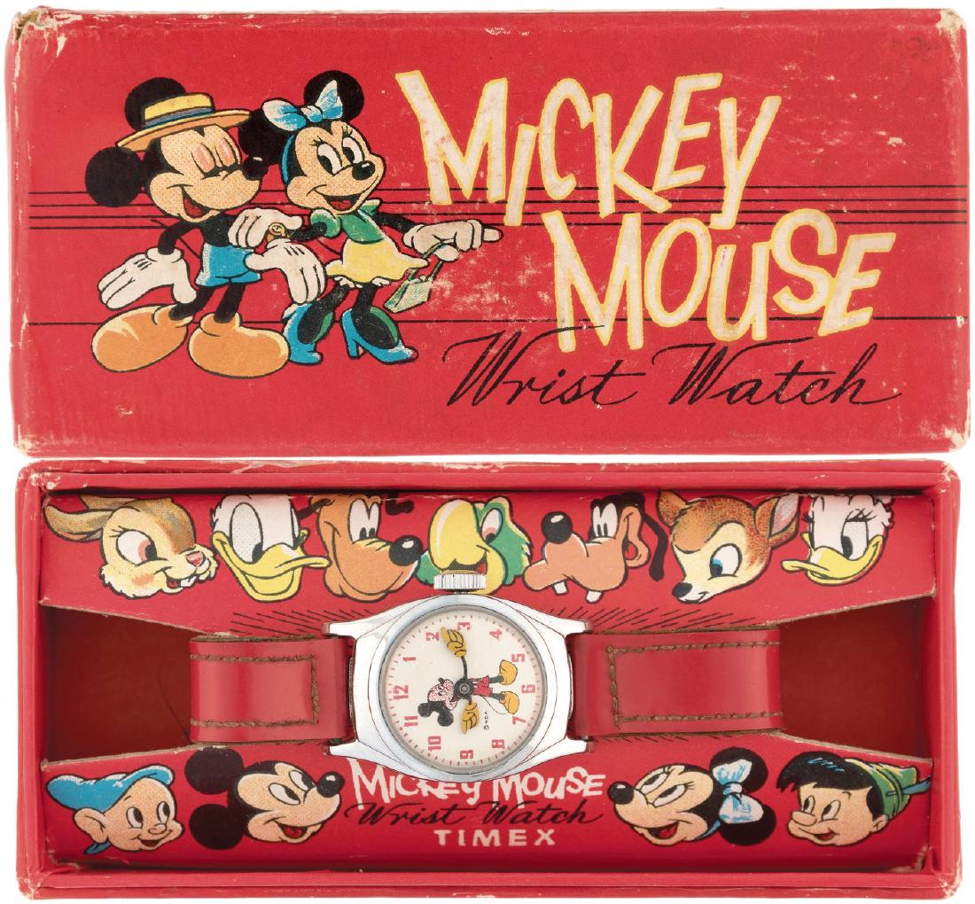 "MICKEY MOUSE WRIST WATCH" BOXED TIMEX WATCH (UK).: 2-1/8x4.5x1" cardboard box w/illustrated lid contains watch similar to previous item #1625, but this version does not have company name on dial. This is 1955 English market only version. Box features