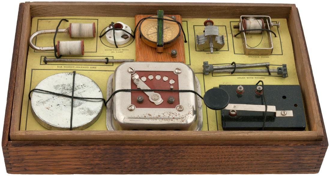 "GILBERT ELECTRICAL SET" BOXED 1916 SET.: 8-1/8x13-1/8x3" deep wooden case contains A.C. Gilbert Co. set, 1916. Case contains wooden insert tray w/labeled thin cardboard liner. Case shows some lt. scattered wear and is VF overall. Comes w/"El